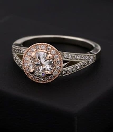 Sparkling diamond engagement ring with a rose gold halo and pave band.